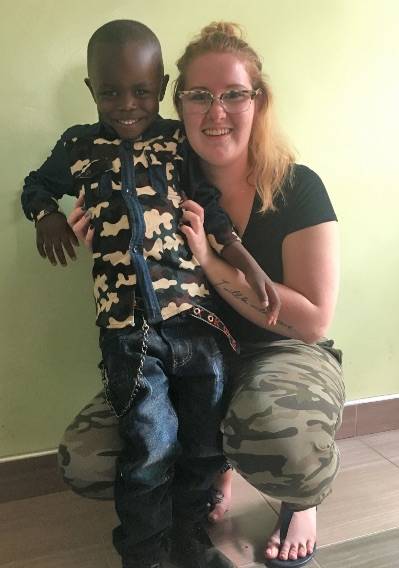 HAPPINESS - Lynzee Berreth strikes a pose with her sponsor child while in Africa with a team from Home of Hope. photo submitted