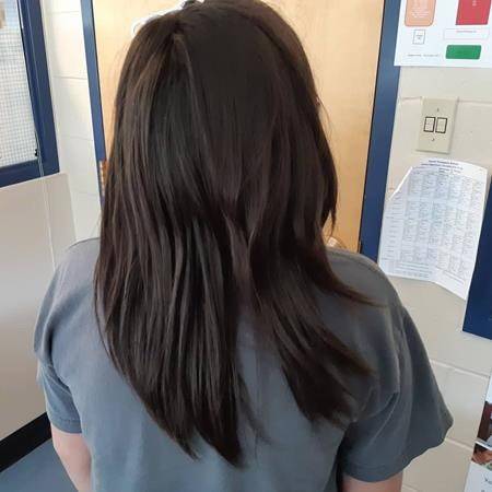 Rafe Vadnais shows his hair after his braid was cut off by a fellow student. (Shantel Tallow via the Canadian Press)