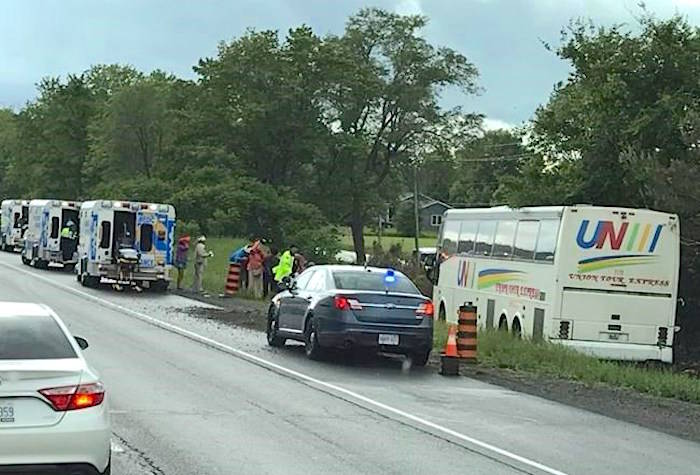 A bus involved in a crash near Prescott, Ont. is shown at the side of Highway 401 in a handout photo. Ontario Provincial Police say at least 24 people are in hospital, four with life-threatening injuries, following a bus crash in eastern Ontario.THE CANADIAN PRESS/HO