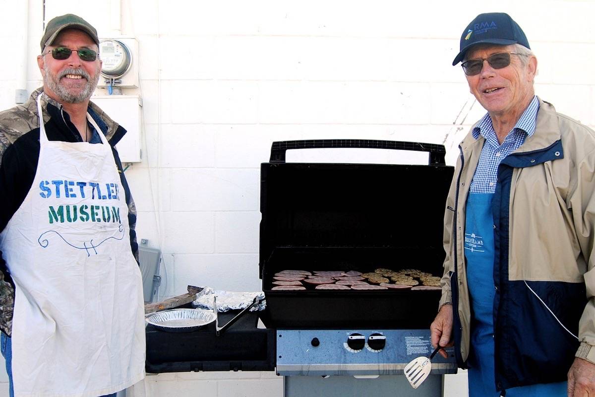 Kevin Blumhagen, left, and Stettler County Coun. Wayne Nixon volunteer at Stettler Town and Country Museum’s pancake breakfast June 2. (Lisa Joy/Stettler Independent)