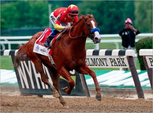 Justify, with jockey Mike Smith up, crosses the finish line to win the 150th running of the Belmont Stakes horse race and the Triple Crown, Saturday, June 9, 2018, in Elmont, N.Y. (AP Photo/Peter Morgan)