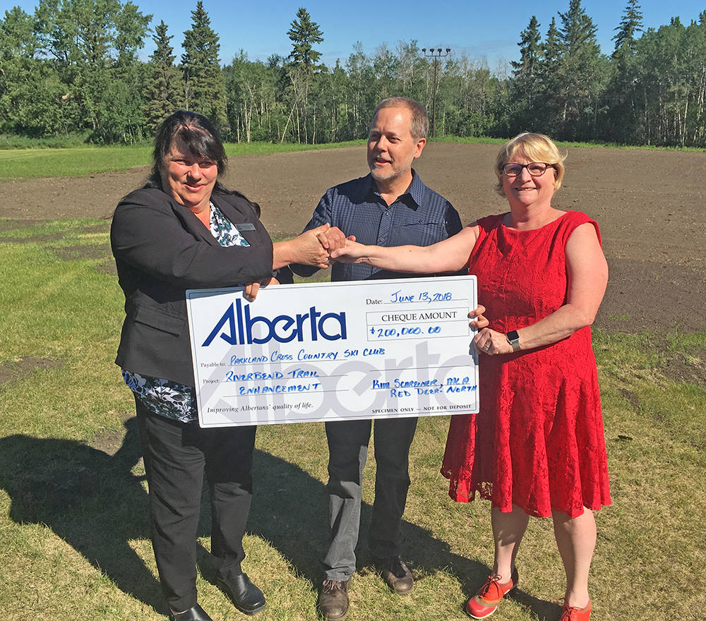 FUNDING - Red Deer-North MLA Kim Schreiner, Tom Marr-Laing, president of Parkland Cross-Country Ski Club and Barb Miller, MLA for Red Deer-South are pictured during a funding announcement for trail enhancements at the River Bend Golf and Recreation Area. Mark Weber/Red Deer Express