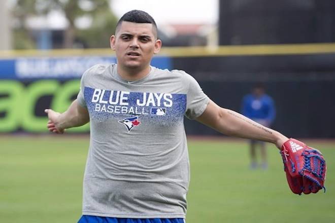 Toronto Blue Jays relief pitcher Roberto Osuna warms up at Spring Training in Dunedin, Fla., on February 13, 2018. A lawyer for Roberto Osuna says the Toronto Blue Jays closer will not be in court today for his first appearance to face an assault charge. Domenic Basile says he will appear on Osuna’s behalf. The 23-year-old pitcher was charged with one count of assault by Toronto police early last month. THE CANADIAN PRESS/Frank Gunn