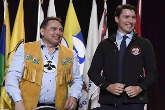 Prime Minister Justin Trudeau looks on after receiving an Assembly of First Nations jacket as a gift from AFN National Chief Perry Bellegarde, left, after his speech at the AFN’s Special Chiefs Assembly in Gatineau, Que., on Wednesday, May 2, 2018. THE CANADIAN PRESS/Justin Tang