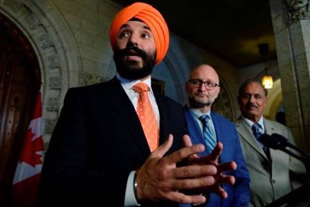 Minister of Innovation, Science and Economic Development Navdeep Bains makes an announcement on digital and data transformation, as Parliamentary Secretary to the Minister of Innovation, Science and Economic Development David Lametti and Liberal MP Jati Sidhu look on, in the Foyer of the House of Commons on Parliament Hill in Ottawa on Tuesday, June 19, 2018. (Justin Tang/The Canadian Press)