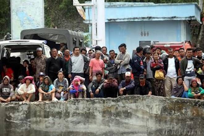 Relatives of victims of a sunken ferry wait for news at the Tigaras port in Toba lake, North Sumatra, Wednesday, June, 20, 2018. Distraught relatives slammed Indonesia’s government for not enforcing basic safety measures on passenger boats and pleaded Wednesday for a bigger search effort for the people missing since a ferry sank on a picturesque Sumatran lake early this week. (AP Photo/Binsar Bakkara)