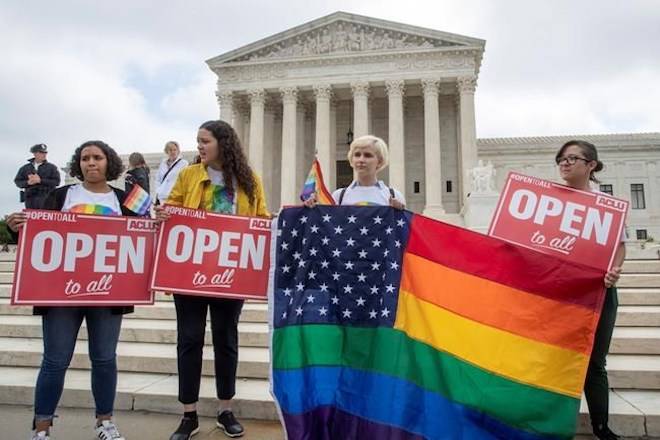 In this June 4, 2018 photo, American Civil Liberties Union activists demonstrate in front of the Supreme Court in Washington. (AP Photo/J. Scott Applewhite)