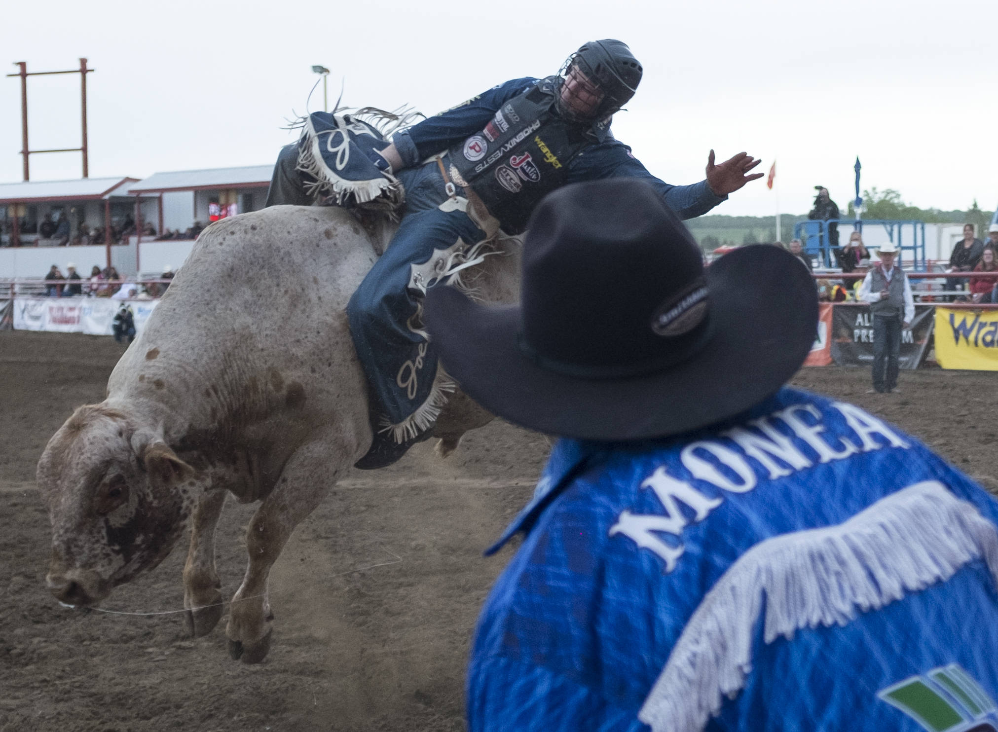 Bull fighter Brett Monea keeps a close eye on this bull rider as the first day of the Ponoka Stampede closes with the bull riding event.                                Photos by Jeffrey Heyden-Kaye