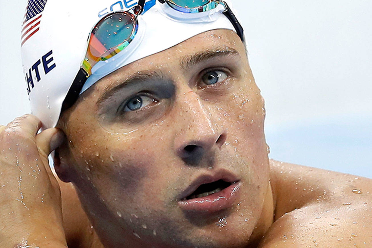FILE - In this Tuesday, Aug. 9, 2016, file photo, United States’ Ryan Lochte checks his time in a men’s 4x200-meter freestyle heat during the swimming competitions at the 2016 Summer Olympics, in Rio de Janeiro, Brazil. (AP Photo/Michael Sohn, File)