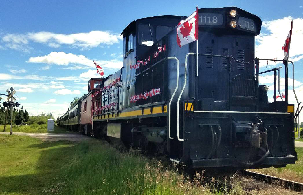 Stettler’s Alberta Pairie Railway tourist attraction decks out its train with Canadian flags for Canada Day. Engine 1118 with engineer Jim Potter at the controls takes the 200 people onboard to Big Valley July 1. (TIM PROVEN photo)