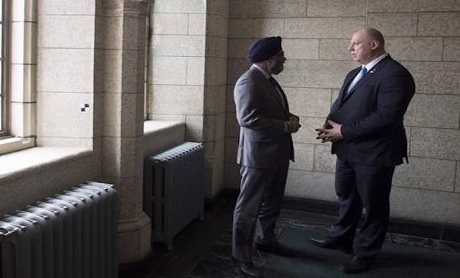 Canadian Minister of National Defence Minister Harjit Sajjan, left, speaks with Latvian Defence Minister Raimonds Bergmanis on Parliament Hill in Ottawa, Wednesday, January 31, 2018. Prime Minister Justin Trudeau will visit Canadian troops in Latvia before attending the NATO Summit next week. THE CANADIAN PRESS/Adrian Wyld
