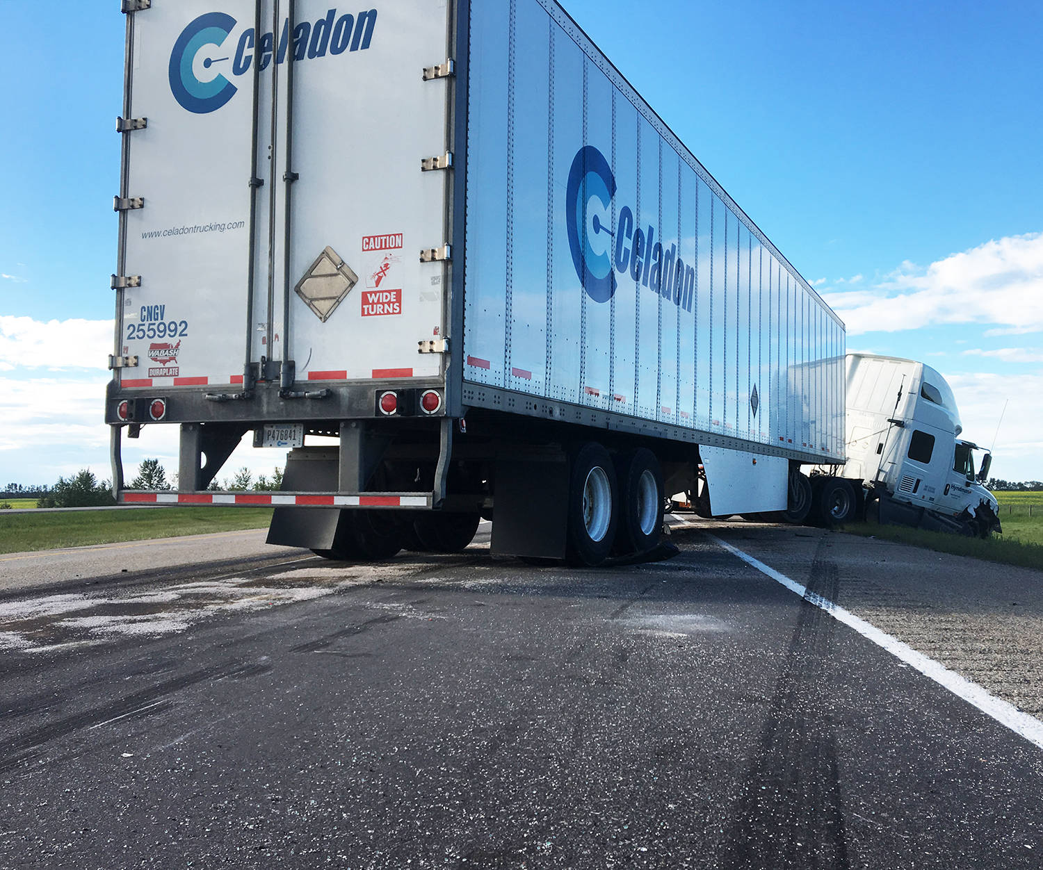 Tire skid marks show where the semi tractor attempted to avoid colliding with the two vehicles.