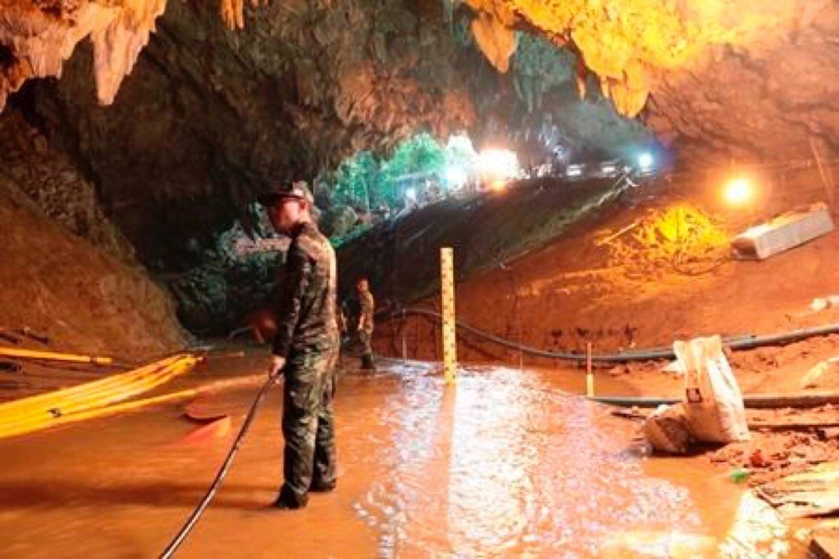 In this undated photo released by Royal Thai Navy on Saturday, July 7, 2018, Thai rescue teams arrange water pumping system at the entrance to a flooded cave complex where 12 boys and their soccer coach have been trapped since June 23, in Mae Sai, Chiang Rai province, northern Thailand. (Royal Thai Navy via AP)
