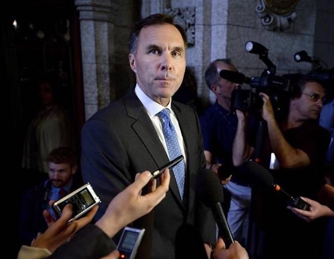 Minister of Finance Bill Morneau speaks to reporters as he arrives for Question Period in the House of Commons on Parliament Hill in Ottawa on June 18, 2018. THE CANADIAN PRESS/Justin Tang