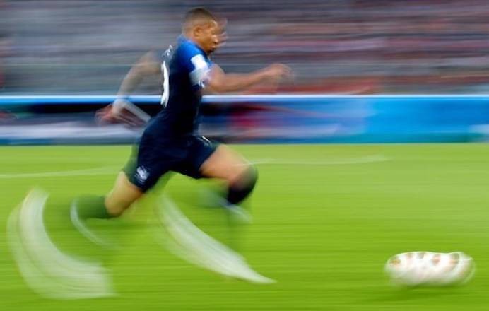 In this photo taken with slow shutter speed France’s Kylian Mbappe runs with the ball during the semifinal match between France and Belgium at the 2018 soccer World Cup in the St. Petersburg Stadium, in St. Petersburg, Russia, Tuesday, July 10, 2018. (AP Photo/Petr David Josek)