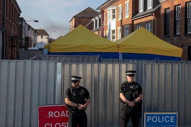 Police secure a point of interest in Salisbury, where counter-terrorism officers are investigating after a woman and her partner were exposed to the nerve agent Novichok, Monday July 9, 2018. (Steve Parsons/PA via AP)