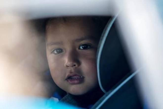 Ever Reyes Mejia’s 3-year-old son is loaded into a car after they were reunited at the U.S. Immigration and Customs Enforcement (ICE) office building in Grand Rapidson Tuesday, July 10, 2018. (Cory Morse/The Grand Rapids Press via AP)