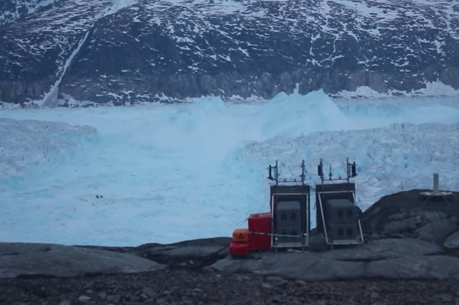 A team of NYU scientists has captured on video a four-mile iceberg breaking away from a glacier in eastern Greenland. Image/YouTube screenshot/New York University