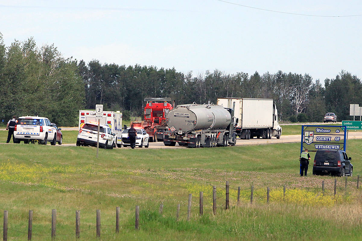 RCMP and Sheriffs from the Ponoka Integrated Traffic Unit check out the vehicle in the ditch and look further into things on the QEII just north of the overpass with Secondary Highway 611 after a woman ran out into traffic. Fortunately, she wasnt’t hurt. Photo by Jordie Dwyer