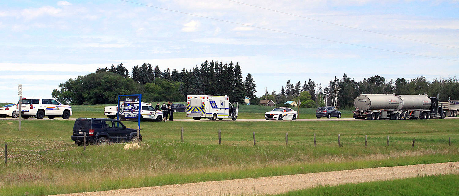 The Ponoka Integrated Traffic Unit speak to witnesses after a woman drove into the ditch on Highway 2 before running in front of the semi-trailer tanker unit shown. Miraculously, the driver was able to stop in time, though Sheriffs had to talk her down after she climbed up and over the cab to sit on top of the tank trailers. Photo by Jordie Dwyer