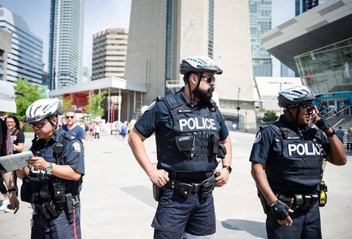 Police are seen in Toronto, on Thursday, July 12, 2018. THE CANADIAN PRESS/Christopher Katsarov