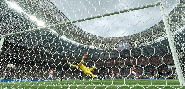 Croatia’s Ivan Perisic, partially obscured at right, scores his sides first goal past France goalkeeper Hugo Lloris during the final match between France and Croatia at the 2018 soccer World Cup in the Luzhniki Stadium in Moscow, Russia, Sunday, July 15, 2018. (AP Photo/Martin Meissner)