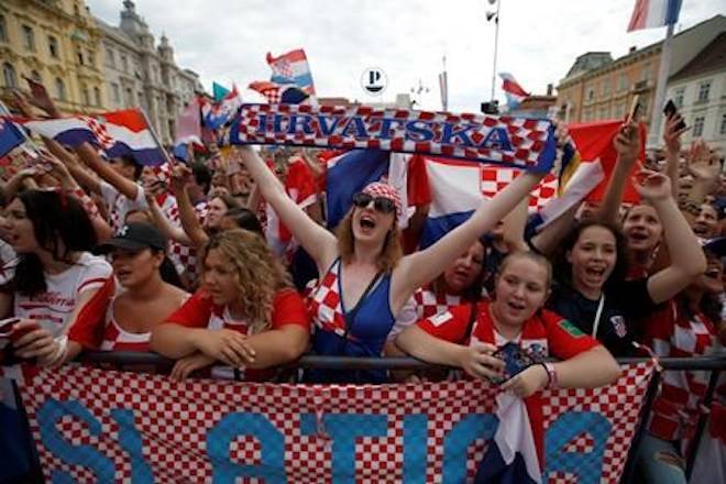 Supporter of Croatia national soccer team members wait to welcome the team on their arrival in Zagreb, Croatia, Monday, July 16, 2018. (AP Photo/Darko Vojinovic)