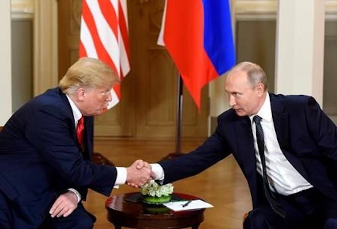 U.S. President Donald Trump, left and Russian President Vladimir Putin shake hands during their meeting in the Presidential Palace in Helsinki, Monday, July 16, 2018.. (Heikki Saukkomaa/Lehtikuva via AP)