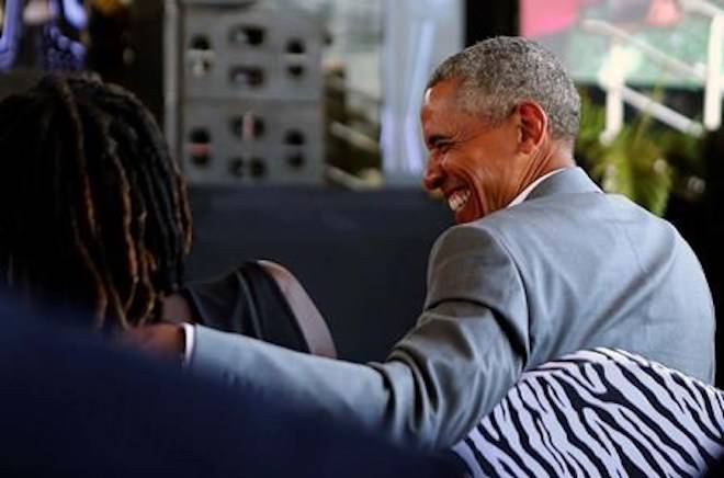 Former US President Barack Obama speaks with his half sister Auma Obama, in Kogelo, Kenya, Monday, July 16, 2018. (AP Photo Brian Inganga)