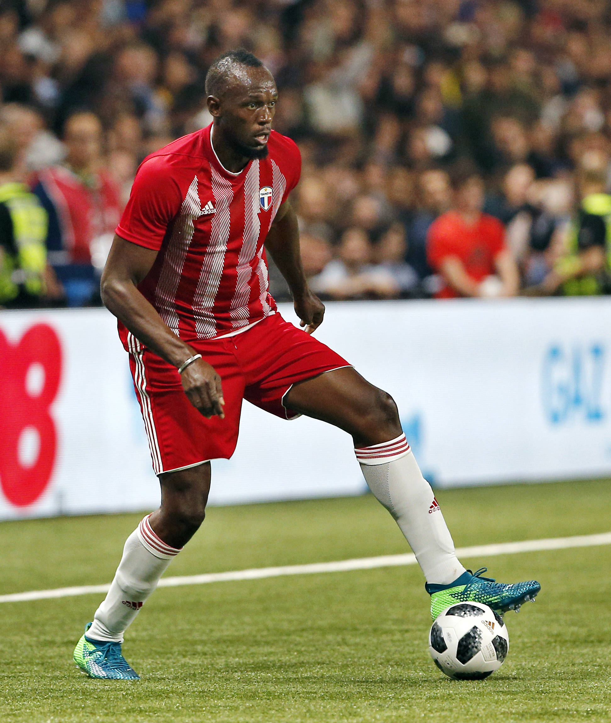 Former Olympic and Jamaican sprinter Usain Bolt controls the ball during a charity soccer match between members of the 1998 World Cup winning French team and a team of international veteran players at the U Arena in Nanterre, north of Paris, France. (AP Photo/Thibault Camus, File)