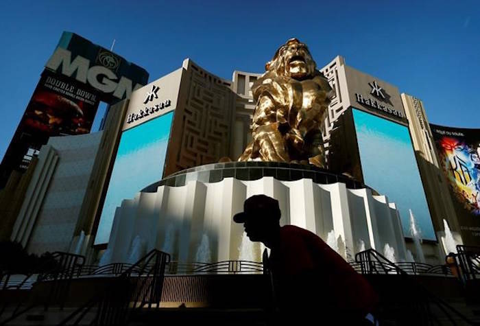 In this Aug. 3, 2015, file photo, a man rides his bike past the MGM Grand hotel and casino in Las Vegas. (AP Photo/John Locher)