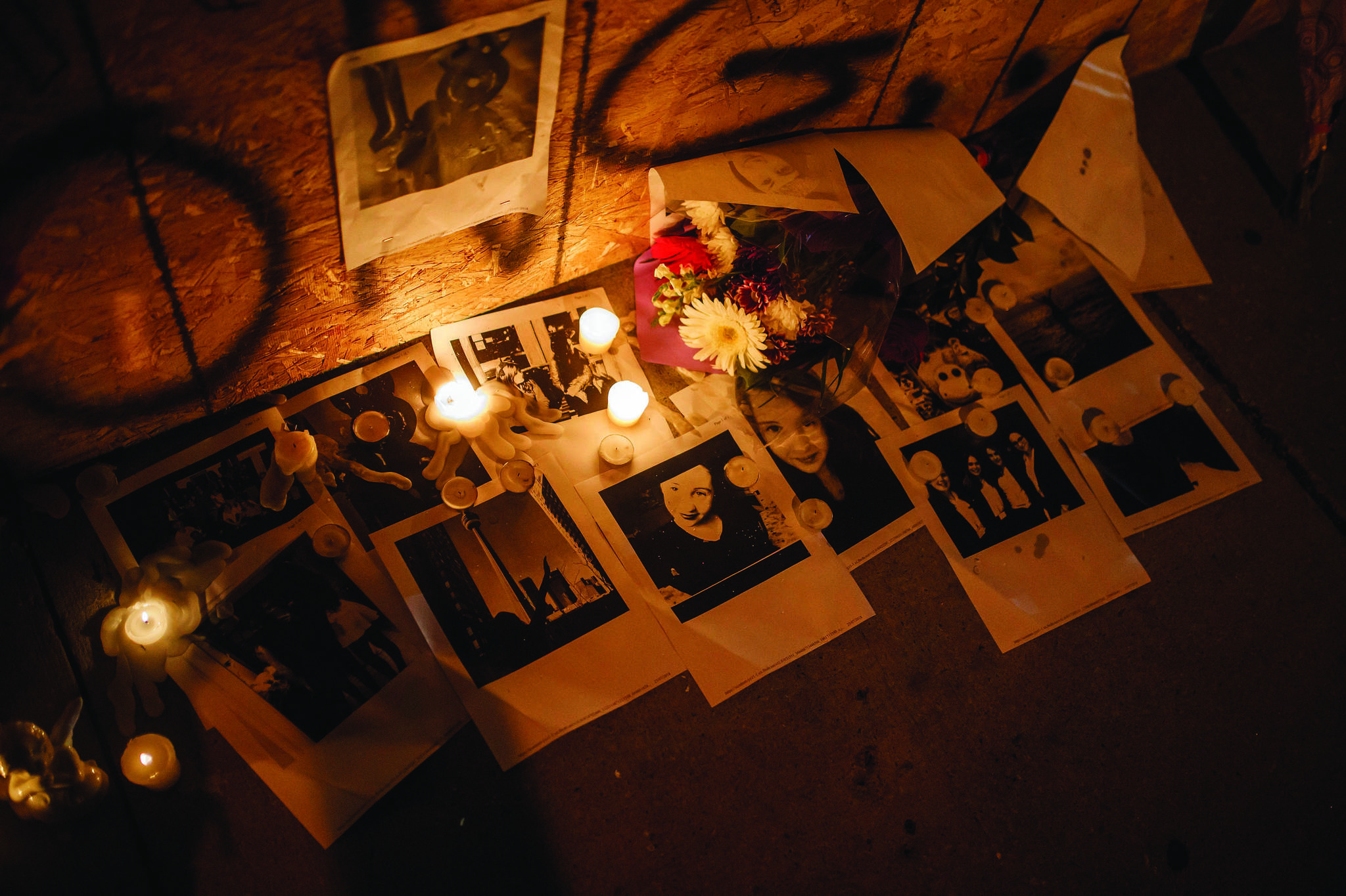 Pictures of Danforth shooting victim Reese Fallon, are left with candles at a makeshift memorial remembering the victims of a shooting on Sunday evening on Danforth, Ave. in Toronto on Monday, July 23, 2018. (Mark Blinch/The Canadian Press)