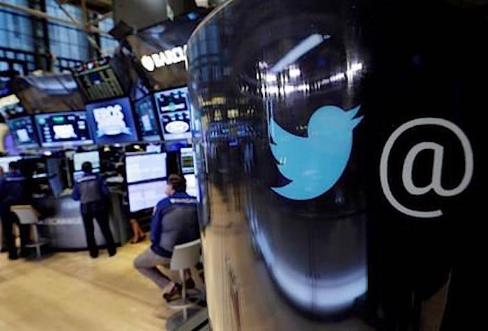 In this Oct. 13, 2015, file photo, the Twitter logo appears on a phone post on the floor of the New York Stock Exchange. (AP Photo/Richard Drew, File)