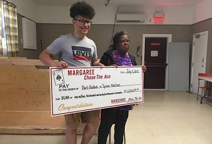 Tyrone MacInnis, left, and Barb Reddick, right, accept their Chase the Ace lottery prize in this undated handout photo. THE CANADIAN PRESS/HO, Bernice Curley, Chase The Ace Margaree