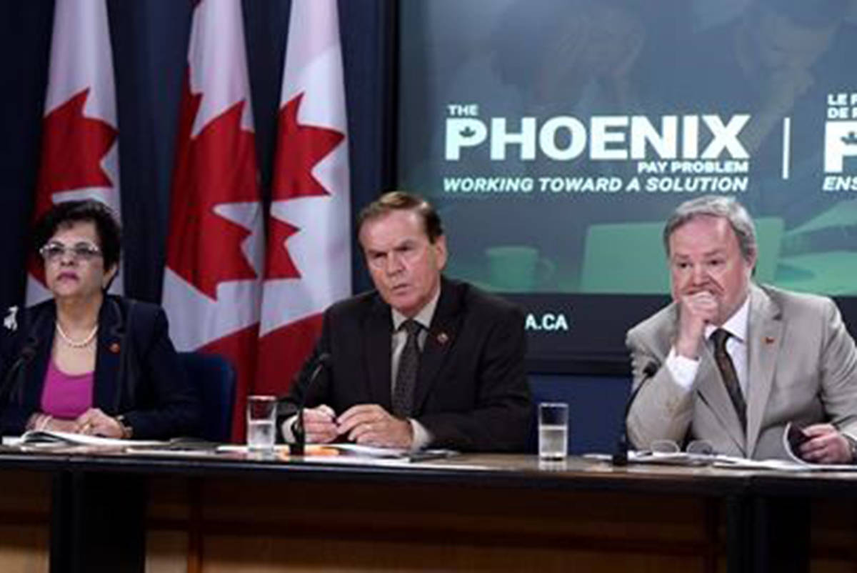 Sen. Percy Mockler, centre, chair of the Standing Senate Committee on National Finance, sits with deputy chairs Sen. Mobina Jaffer, left, and Sen. Andre Pratte, of the Standing Senate Committee on National Finance, listen to questions during a press conference on their report on the Phoenix pay system, in Ottawa on Tuesday, July 31, 2018. (Justin Tang/The Canadian Press)