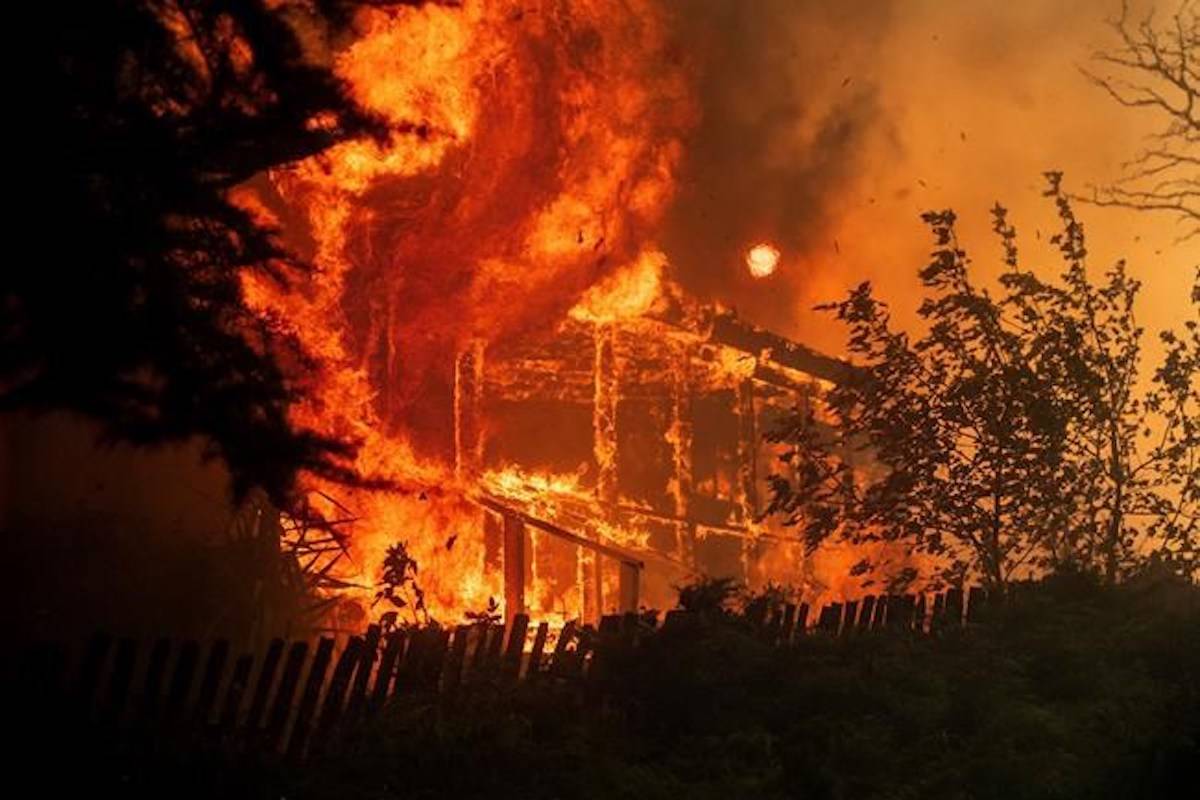 Flames consume a home as the River Fire tears though Lakeport, Calif., on Tuesday, July 31, 2018. (AP Photo/Noah Berger)