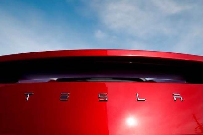 FILE - In this April 15, 2018, file photo, the sun shines off the rear deck of a roadster on a Tesla dealer’s lot in the south Denver suburb of Littleton, Colo. (AP Photo/David Zalubowski, File)