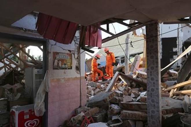 Rescue teams search for victims in the rubble caused by an earthquake in North Lombok, Indonesia, Monday, Aug. 6, 2018. (AP Photo/Tatan Syuflana)