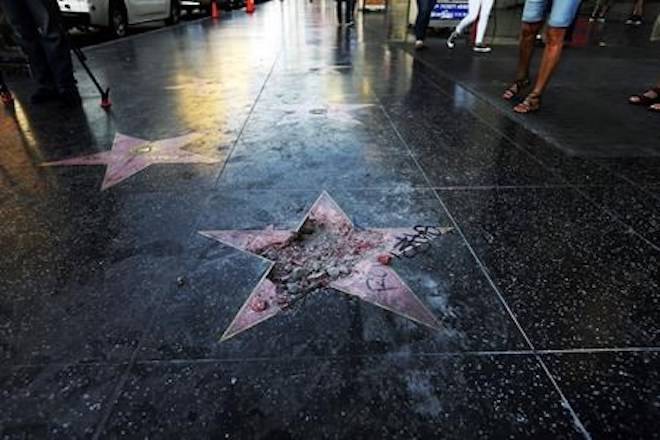 FILE - This July 25, 2018, file photo shows Donald Trump’s vandalized star on the Hollywood Walk of Fame in Los Angeles. The West Hollywood City Council has unanimously approved a resolution seeking to remove President Donald Trump’s star from the Hollywood Walk of Fame. (AP Photo/Reed Saxon, File)