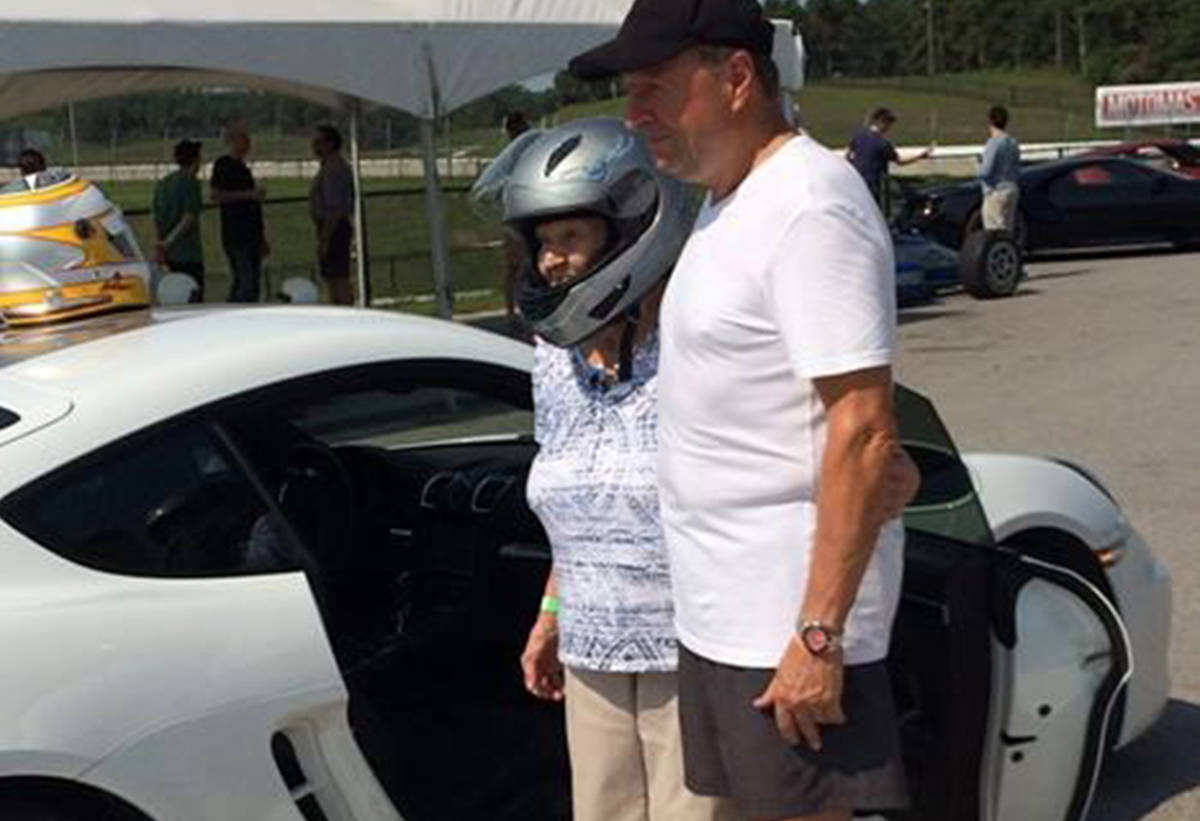 90-year-old Maire Hollo poses for a photo with Canadian Motorsport Hall of Fame member Peter Lockhart at the Canadian Tire Motorsport Park in this undated handout photo. A great-grandmother spent her 90th birthday going over 200 kilometres an hour on a racetrack, and she’s not slowing down on the fun anytime soon. (Susan Hollo Wontorra)
