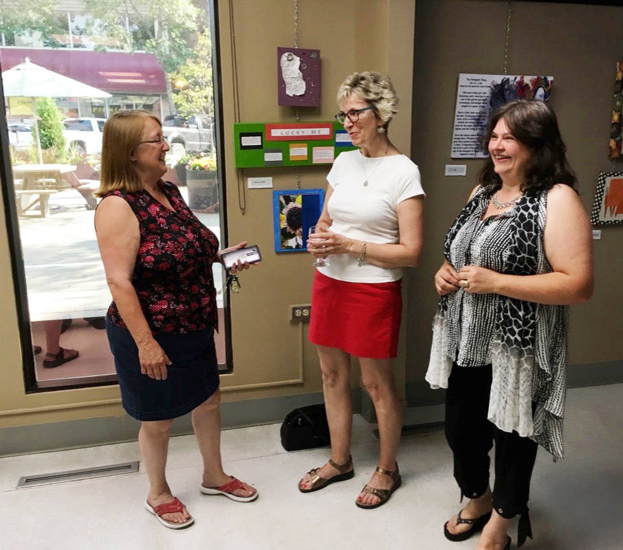 From left, Patricia O’Neill, Fran Kimmel and Elena Rousseau enjoy a visit during the opening reception for Age on a Page, a new literary art exhibit from Writers’ Ink.                                Mark Weber/Red Deer Express