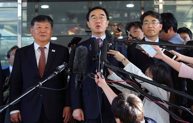 FILE - In this June 1, 2018, file photo, South Korean Unification Minister Cho Myoung-gyon, center, speaks to the media before leaving for the border village of Panmunjom to attend South and North Korean meeting, at the Office of the South Korea-North Korea Dialogue in Seoul, South Korea. (AP Photo/Ahn Young-joon, File)