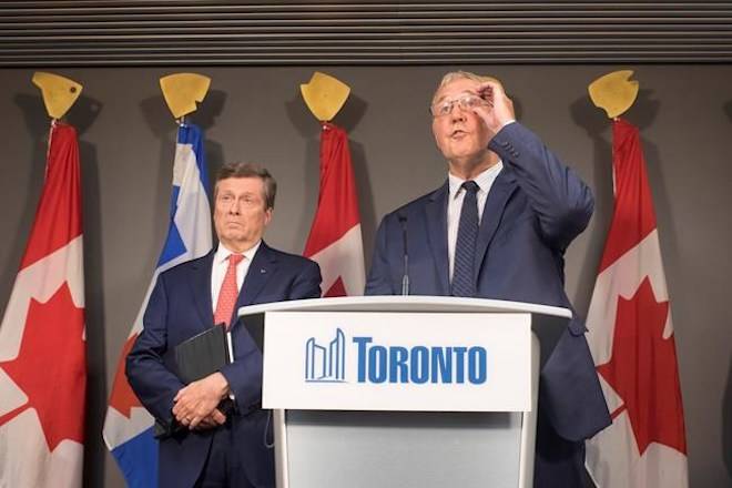 Bill Blair (right), federal minister of border security and organized crime reduction, and Mayor John Tory attend a press conference in Toronto on Friday, August 3, 2018. THE CANADIAN PRESS/Chris Young