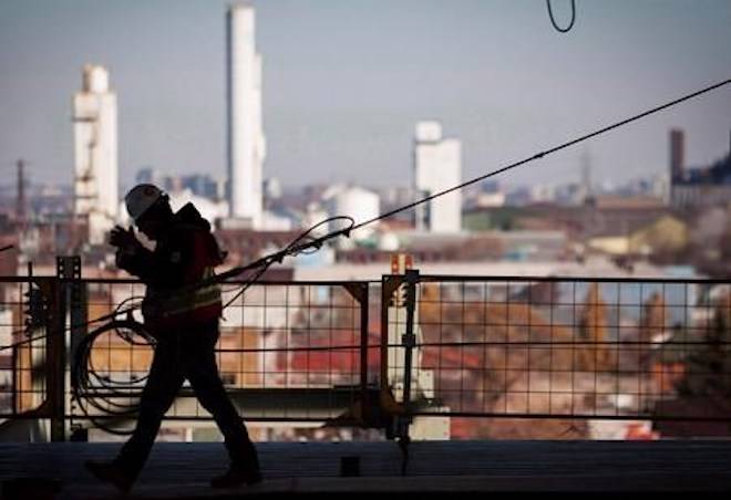 A worker walks on a construction site in Hamilton, Ont., on November 14, 2013. THE CANADIAN PRESS/Aaron Lynett