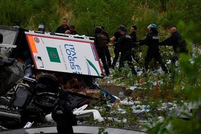 Rescues work among the debris of the collapsed Morandi highway bridge in Genoa, Tuesday, Aug. 14, 2018. (Luca Zennaro/ANSA via AP)