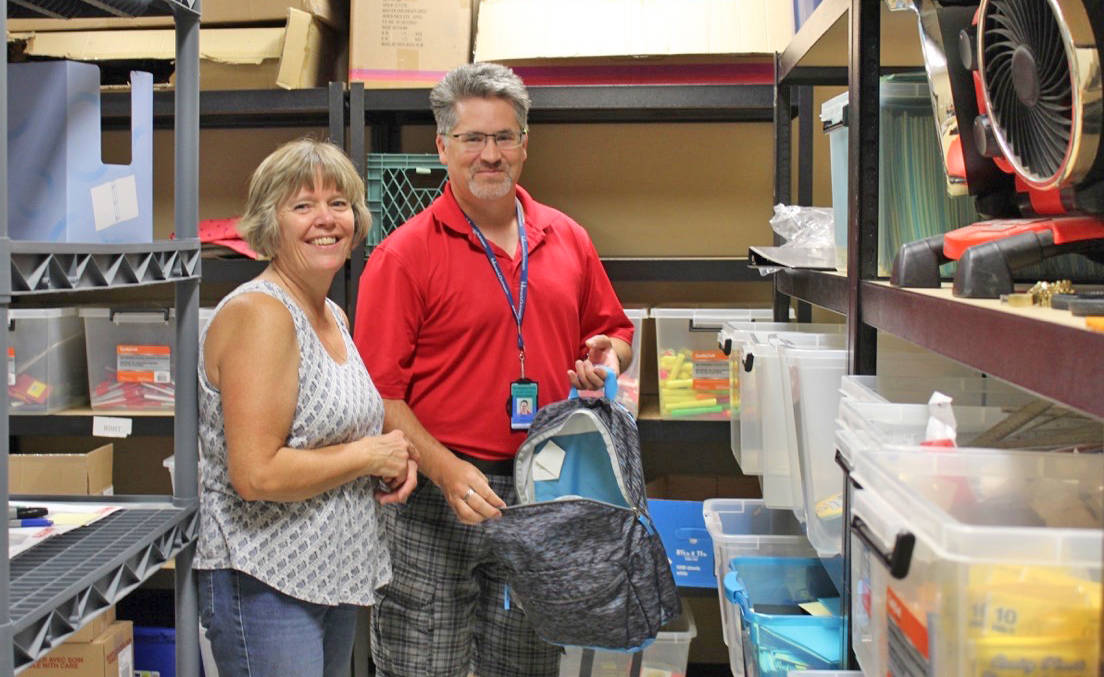 Anne Krejci and Darcy Ouellet standing with a few of the supplies donated so far to the Tools for Schools program. Carlie Connolly/Red Deer Express