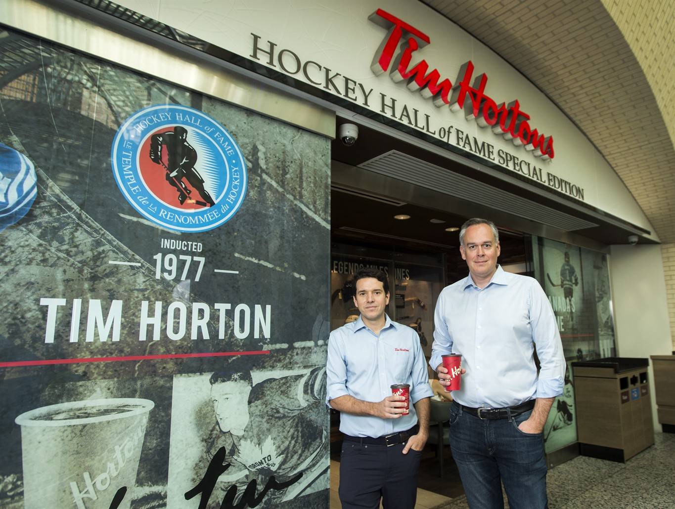 Alex Macedo, left, president at Tim Hortons and Duncan Fulton, chief corporate officer at Restaurant Brands International pose for a photograph at the Hockey Hall of Fame Tim Hortons location in Toronto on Thursday, August 16, 2018. THE CANADIAN PRESS/Nathan Denette