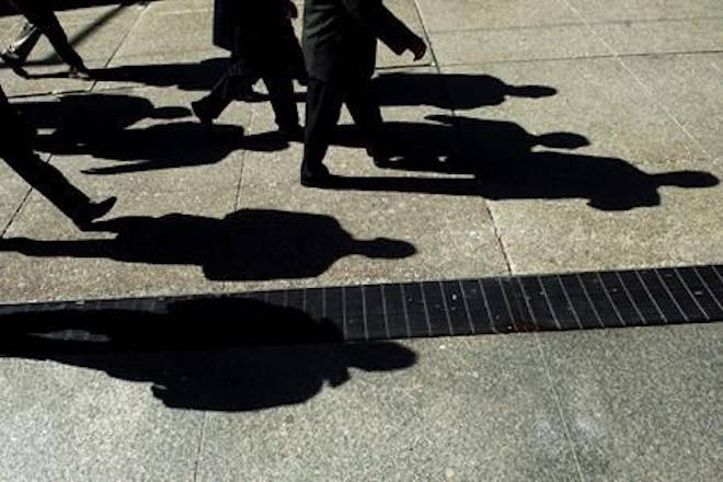 An overwhelming majority of federal government auditors believe Canada’s tax system unfairly favours the wealthy over average Canadians, according to a recent union-sponsored survey. Businessmen cast their shadows as they walk in Toronto’s financial district on Monday, Feb. 27, 2012. THE CANADIAN PRESS/Nathan Denette