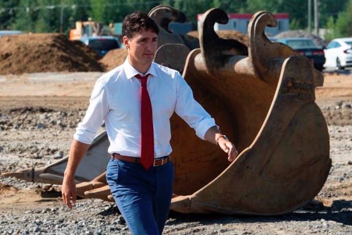 Prime Minister Justin Trudeau walks through a construction area before participating in a ground breaking ceremony for an Amazon distribution centre in Ottawa, Monday August 20, 2018. (THE CANADIAN PRESS/Adrian Wyld)