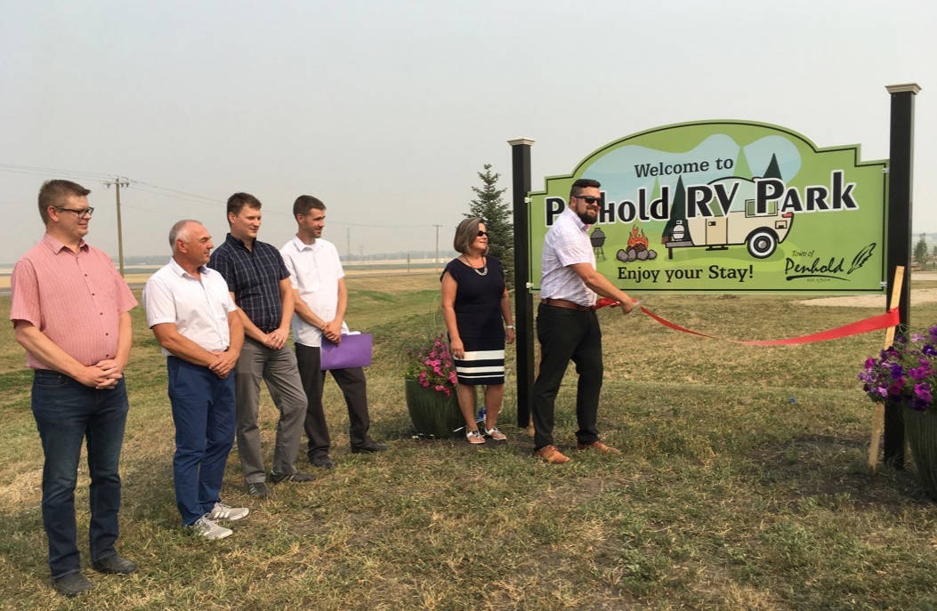 Penhold Mayor Mike Yargeau cuts the ribbon marking the official opening of the Penhold RV Park on Aug. 23rd. The site, which features 67 fully serviced sites, is located adjacent to the Regional Multiplex.                                Mark Weber/Red Deer Express